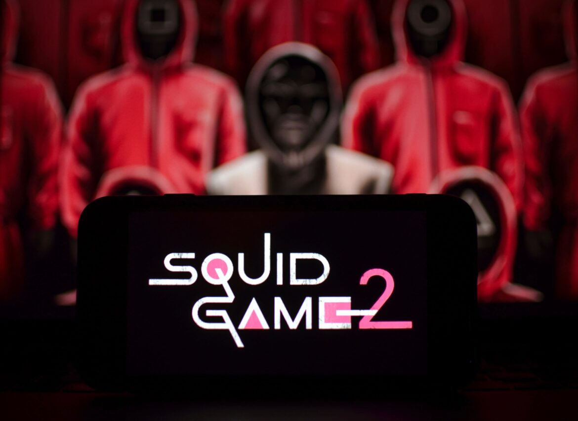 Netflix's Squid Game 2 trailer out (Ojingeo geim) logo displayed on smartphone screen. Going to break previous records?