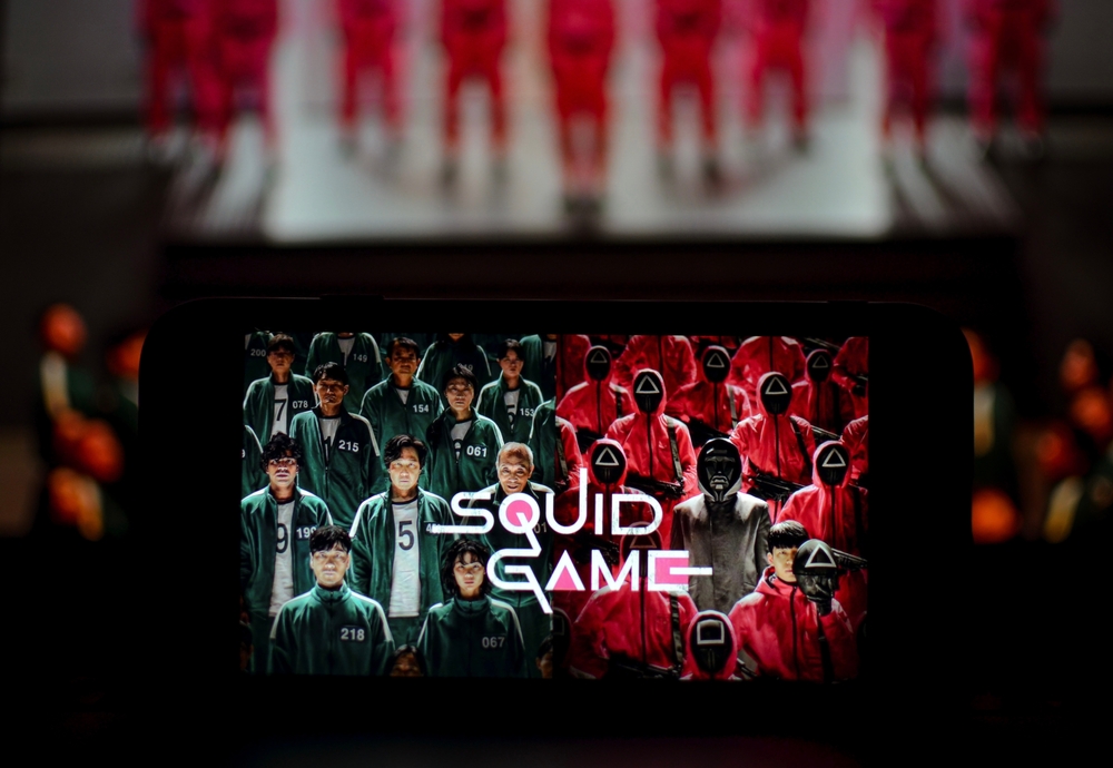 Squid Game (Ojingeo geim) logo displayed on smartphone screen. New Netflix