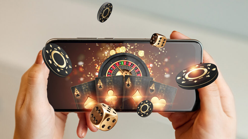 Close up of a smartphone in hands and playing online rummy game in it representing the concept of the rise of mobile gaming